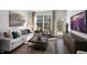 Gathering room with hardwood floors, a comfy sofa, and access to backyard at 2332 Sugar Cone Way, Fuquay Varina, NC 27526