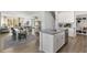 Open kitchen with island, white cabinets, and a view into the dining area at 2332 Sugar Cone Way, Fuquay Varina, NC 27526