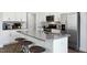 Modern kitchen with white cabinets, gray countertops, and stainless steel appliances at 2332 Sugar Cone Way, Fuquay Varina, NC 27526