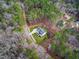 Aerial view showing home's location in a wooded area with a driveway at 257 Rawhide Dr, Louisburg, NC 27549