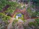 Aerial view showcases a home nestled in a quiet wooded neighborhood at 257 Rawhide Dr, Louisburg, NC 27549