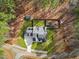 Aerial view shows a home on a wooded lot with a spacious backyard at 257 Rawhide Dr, Louisburg, NC 27549