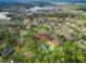 Aerial view shows home near a lake and surrounded by lush greenery at 257 Rawhide Dr, Louisburg, NC 27549