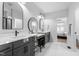 Elegant bathroom with double vanity, walk-in shower, and large mirrors at 257 Rawhide Dr, Louisburg, NC 27549