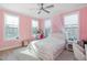 Spacious bedroom with pink walls, plush bedding, and ample natural light at 257 Rawhide Dr, Louisburg, NC 27549