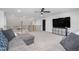 Spacious bonus room with sectional sofa and large TV at 257 Rawhide Dr, Louisburg, NC 27549