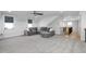 Large bonus room with grey sectional sofa and ample natural light at 257 Rawhide Dr, Louisburg, NC 27549