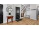 Bright entry with built-in bench, hardwood floors, and modern lighting at 257 Rawhide Dr, Louisburg, NC 27549