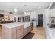 Eat-in kitchen with large island, white cabinets, and farmhouse sink at 257 Rawhide Dr, Louisburg, NC 27549