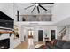 Two-story living room with a loft and a stone fireplace at 257 Rawhide Dr, Louisburg, NC 27549