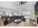 L-shaped sectional sofa faces a stone fireplace and kitchen at 257 Rawhide Dr, Louisburg, NC 27549