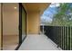 This balcony features a black iron railing and looks into the lush surrounding landscaping at 29 Enterprise St # 107, Raleigh, NC 27607