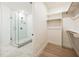 This bathroom features a glass shower and a bright walk-in closet with custom shelving at 29 Enterprise St # 107, Raleigh, NC 27607