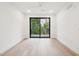 Bright bedroom features hardwood floors, recessed lighting, ceiling fan and glass doors leading to balcony at 29 Enterprise St # 107, Raleigh, NC 27607