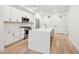 Open concept kitchen with white cabinetry, stainless steel appliances, and a center island at 29 Enterprise St # 107, Raleigh, NC 27607