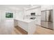 Bright kitchen featuring white cabinetry, stainless steel appliances, and a large center island at 29 Enterprise St # 107, Raleigh, NC 27607