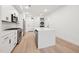 Modern kitchen with stainless steel appliances, white cabinets, and a center island at 29 Enterprise St # 107, Raleigh, NC 27607