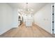 Open floor plan featuring a modern kitchen and spacious living area with hardwood floors at 29 Enterprise St # 107, Raleigh, NC 27607