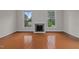 Bright bedroom featuring hardwood floors, fireplace, and large windows at 309 Hawkins Ave, Sanford, NC 27330