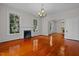 Large dining room with hardwood floors, fireplace, and chandelier at 309 Hawkins Ave, Sanford, NC 27330