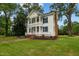Two-story white house with blue shutters, wraparound porch, and landscaped lawn at 309 Hawkins Ave, Sanford, NC 27330