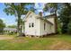 Side view of two-story white house with screened porch and landscaped yard at 309 Hawkins Ave, Sanford, NC 27330