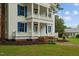 Front view of two-story white house with blue shutters and wraparound porch at 309 Hawkins Ave, Sanford, NC 27330