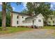 Side view of two-story white house with screened porch and landscaped yard at 309 Hawkins Ave, Sanford, NC 27330