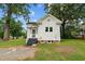Rear view of two-story white house with screened porch and gravel driveway at 309 Hawkins Ave, Sanford, NC 27330