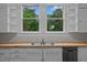 Kitchen boasts a double sink, wood countertop and view to backyard at 309 Hawkins Ave, Sanford, NC 27330