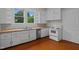 Galley kitchen with white cabinets and wood countertops at 309 Hawkins Ave, Sanford, NC 27330
