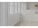 Laundry area with tiled floor and large window at 309 Hawkins Ave, Sanford, NC 27330