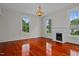 Living room with hardwood floors, fireplace, and large windows at 309 Hawkins Ave, Sanford, NC 27330
