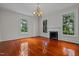 Living room with hardwood floors, fireplace, and large windows at 309 Hawkins Ave, Sanford, NC 27330
