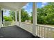 Spacious porch with white railings overlooking a tree-lined street at 309 Hawkins Ave, Sanford, NC 27330
