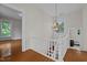 Upper hallway with chandelier and view of adjacent rooms at 309 Hawkins Ave, Sanford, NC 27330