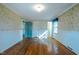 Spacious bedroom with hardwood floors and floral wallpaper at 3129 Barwell Rd Rd, Raleigh, NC 27610