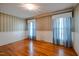 Well-lit bedroom with hardwood floors and floral wallpaper at 3129 Barwell Rd Rd, Raleigh, NC 27610