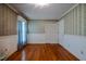 Bedroom with hardwood floors, closet, and floral wallpaper at 3129 Barwell Rd Rd, Raleigh, NC 27610