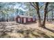 Detached red garage in wooded backyard setting at 3129 Barwell Rd Rd, Raleigh, NC 27610