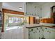 Kitchen with white cabinets and wood paneled walls at 3129 Barwell Rd Rd, Raleigh, NC 27610