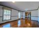 Hardwood floor living room, featuring large windows and green trim at 3129 Barwell Rd Rd, Raleigh, NC 27610