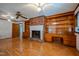 Spacious living room with brick fireplace, built-in shelving, hardwood floors at 3129 Barwell Rd Rd, Raleigh, NC 27610