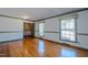 Spacious living room with hardwood floors and large windows at 3129 Barwell Rd Rd, Raleigh, NC 27610