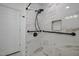 Walk-in shower with marble tile, grab bars, and modern fixtures at 3129 Barwell Rd Rd, Raleigh, NC 27610