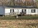 Single-story home with ramp access and wooden steps at 316 Acorn Ct, Rougemont, NC 27572