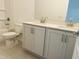 Well-lit bathroom featuring double vanity with shaker cabinets, large mirror, and tub with tiled flooring at 3284 Roundly Rd # 16, New Hill, NC 27562