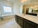 Elegant bathroom features a soaking tub and a vanity with granite countertop and dark wood cabinets at 3284 Roundly Rd # 16, New Hill, NC 27562