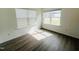 Cozy bedroom area is well-lit by natural light from two windows, showcasing the beautiful wood floor at 3284 Roundly Rd # 16, New Hill, NC 27562
