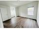 Bright bedroom with hardwood floors, neutral walls, and natural light streaming through windows at 3284 Roundly Rd # 16, New Hill, NC 27562